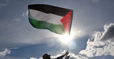 A protester waves a Palestinian flag during a pro-Palestine rally calling for sanctions against Israel outside Parliament House, Canberra, Australia, July 20, 2025. (EPA Photo)