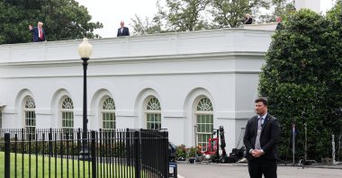 U.S. President Donald Trump waves from the roof as he gets a different view of the proposed ballroom site at the White House in Washington, U.S., Aug. 5, 2025. (Reuters Photo)