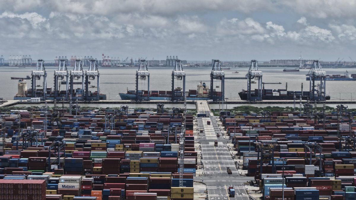 Trucks loaded with containers move through a container terminal port, Shanghai, China, Aug. 7, 2025. (AP Photo)