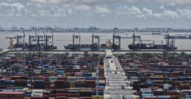 Trucks loaded with containers move through a container terminal port, Shanghai, China, Aug. 7, 2025. (AP Photo)