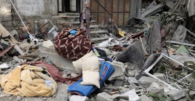 A Palestinian woman inspects the site of an overnight Israeli strike on a house, Gaza City, Palestine, Aug. 7, 2025. (Reuters Photo)
