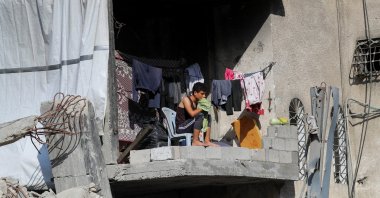 A Palestinian sits at a house previously damaged during the Israeli attacks, Gaza, Palestine, Aug. 6, 2025. (Reuters Photo)