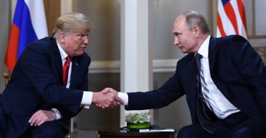 Russian President Vladimir Putin (R) and U.S. President Donald Trump shake hands before a meeting in Helsinki, Finland, July 16, 2018. (AFP File Photo)
