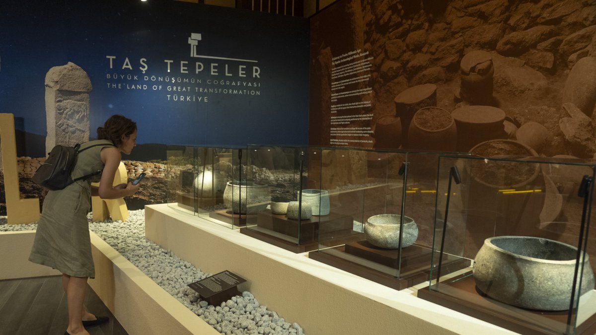 A woman visits the International Archaeology Symposium and Golden Age of Archaeology Exhibition at Göbeklitepe, Şanlıurfa, southeastern Türkiye, Aug. 7, 2025. (AA Photo)