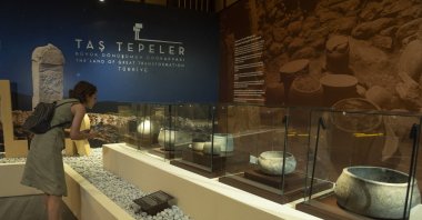 A woman visits the International Archaeology Symposium and Golden Age of Archaeology Exhibition at Göbeklitepe, Şanlıurfa, southeastern Türkiye, Aug. 7, 2025. (AA Photo)