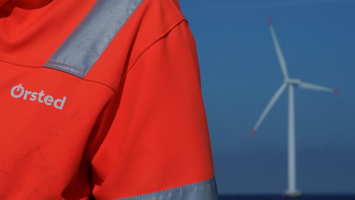 The logo for Orsted can be seen on the jacket worn by an employee as he talks to journalists during a visit to the offshore wind farm near Nysted, Denmark, Sept. 4, 2023. (Reuters Photo)