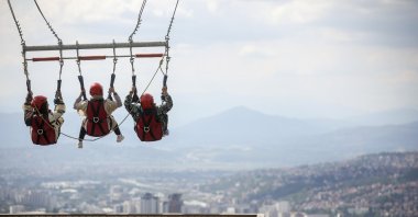 Tourists enjoy a giant swing overlooking the city on Trebevic mountain near Sarajevo, Bosnia-Herzegovina, Aug. 5, 2025. (AP Photo)