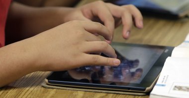  A student uses a tablet during a middle school class in Johns Creek, Georgia., U.S., May 9, 2013. (AP Photo)