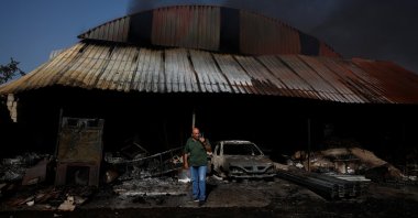 Vicente Bresme reacts as he stands next to a warehouse with his belongings, which burned in a wildfire in Cubo de Benavente, Spain, Aug.11, 2025. (Reuters Photo)