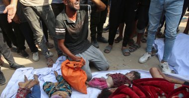 A mourner reacts next to the bodies of Palestinian children from Irheem family, who were killed in an overnight Israeli strike, in Gaza City Aug.11, 2025. (Reuters Photo)