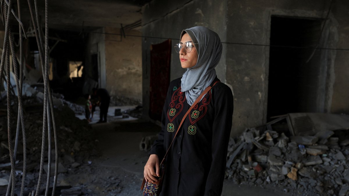 Maha Ali looks at the destruction of the Islamic University of Gaza, where she now shelters, Gaza City, Palestine, June 1, 2025. (Reuters Photo)