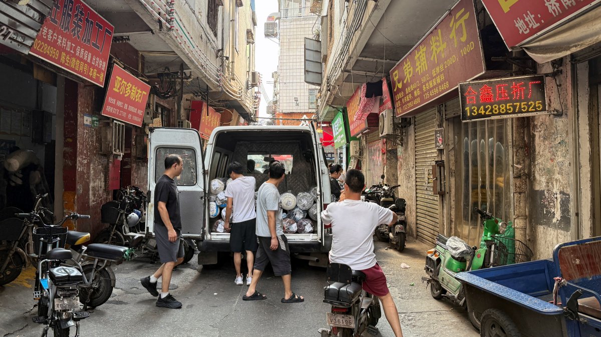 People unload materials from a van outside a small-scale factory in Datang village, Guangzhou, Guangdong Province, China, July 27, 2025. (Reuters Photo)