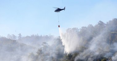 A helicopter extinguishes a fire in Soma, Manisa province, western Türkiye, Aug. 12, 2025. (AA Photo)