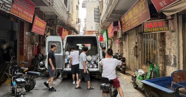 People unload materials from a van outside a small-scale factory in Datang village, Guangzhou, Guangdong Province, China, July 27, 2025. (Reuters Photo)