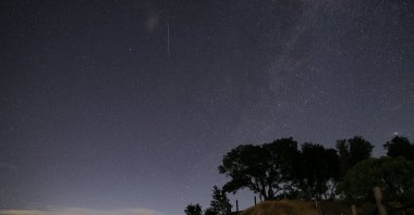 The Perseid meteor shower is seen over Lake Sonoma during its peak, California, U.S. Aug. 12, 2025. (AA Photo)