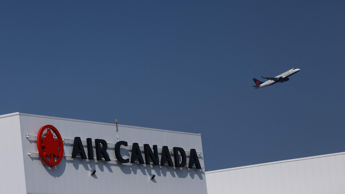 An Air Canada plane takes off behind an Air Canada logo at Pearson International Airport in Toronto, Canada, Aug. 14, 2025. (AFP Photo)