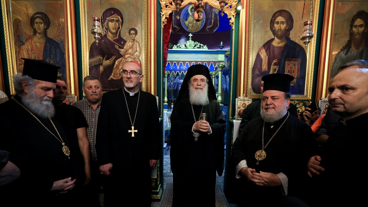 Latin Patriarch of Jerusalem Archbishop Pierbattista Pizzaballa, Greek Orthodox Patriarch of Jerusalem, Theophilos III, Greek Orthodox Patriarchate Archbishop Alexios, and Parish priest Father Gabriele Romanelli, who suffered light leg injuries in an Israeli strike on the Holy Family Church on Thursday, visit the Greek Orthodox Saint Porphyrius Church, in Gaza City July 18, 2025. (Reuters File Photo)