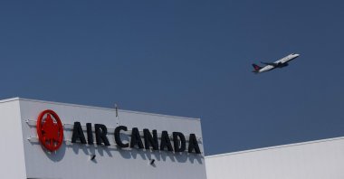 An Air Canada plane takes off behind an Air Canada logo at Pearson International Airport in Toronto, Canada, Aug. 14, 2025. (AFP Photo)