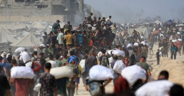 Palestinians carry aid supplies they collected from trucks that entered Gaza through Israel, in Beit Lahia, northern Gaza Strip, Aug. 10, 2025. (Reuters Photo)