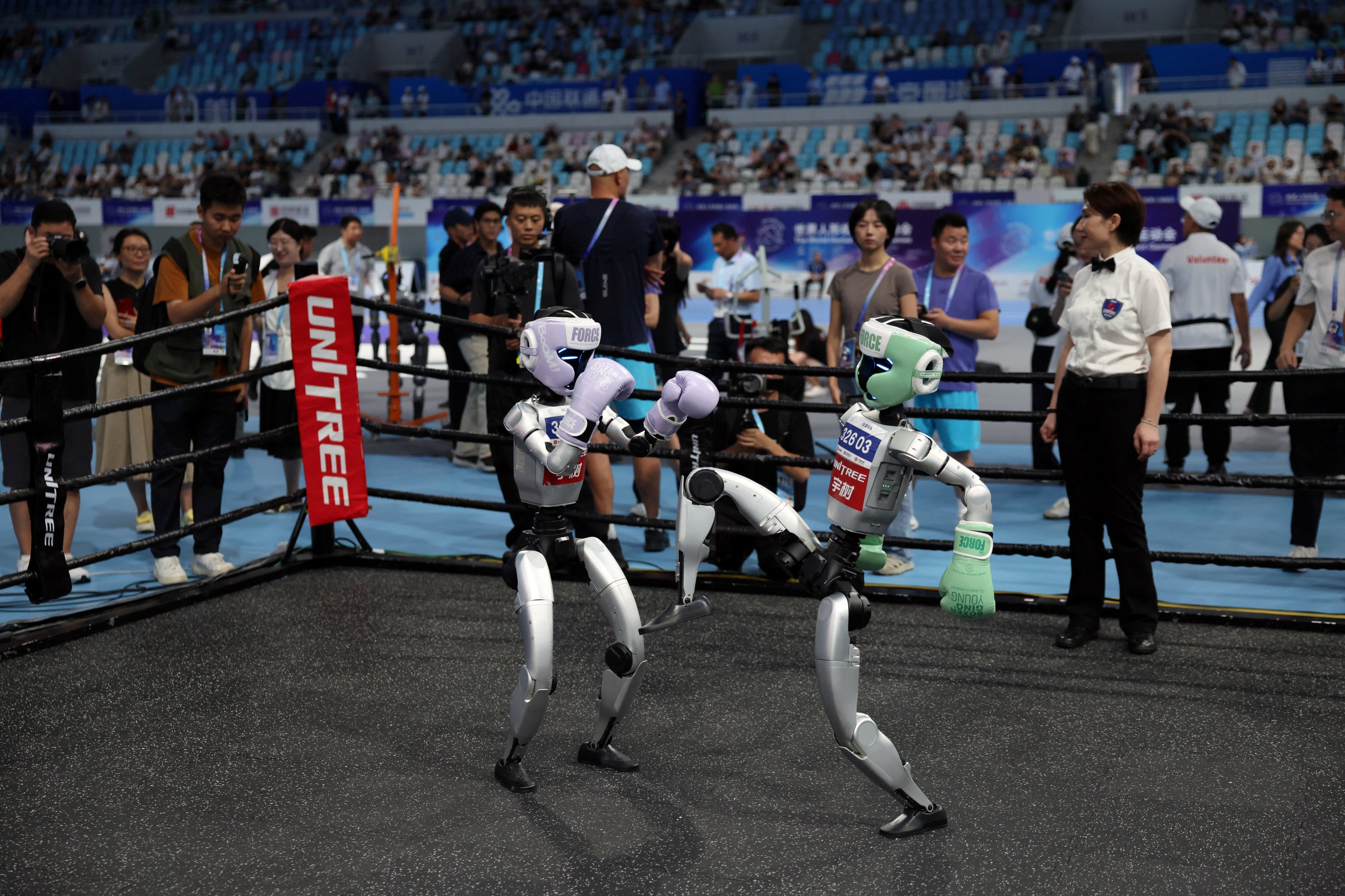 Unitree Robotics humanoid robots compete in a kickboxing match at the inaugural World Humanoid Robot Games, at the National Speed Skating Oval, Beijing, China, Aug. 15, 2025. (Reuters Photo)