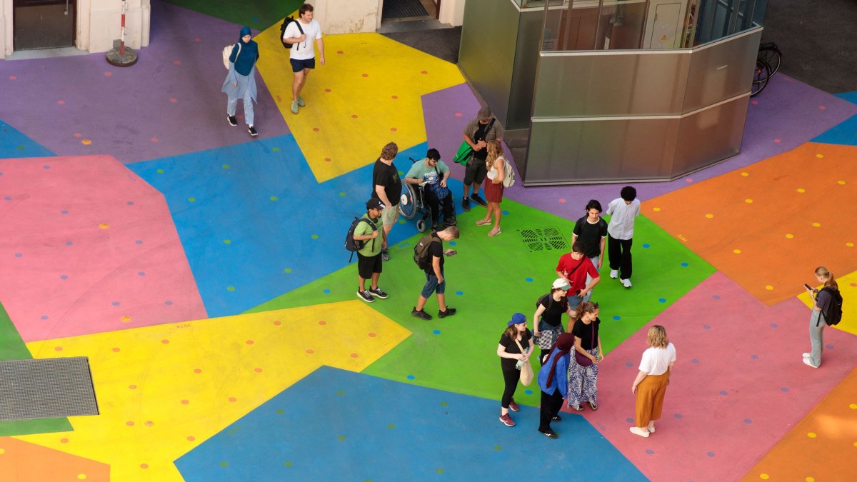 A view from above shows people on the colorfully painted ground in the courtyard of the Heidi Horten museum, Vienna, Austria, Aug. 13, 2025. (AFP Photo)