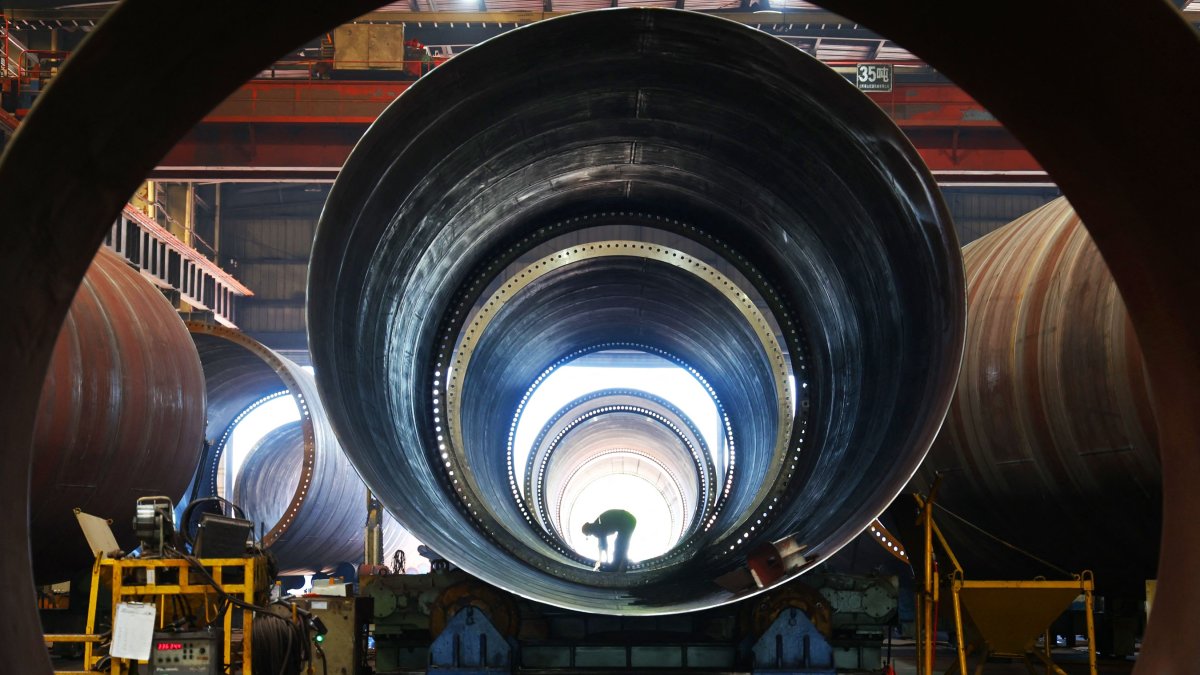 An employee works in a factory, which produces wind turbine towers to be exported overseas, in Lianyungang, China’s eastern Jiangsu province, July 29, 2025. (AFP Photo)