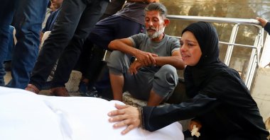 Mourners react next to a body during the funeral of Palestinians killed in Israeli fire while seeking aid at Al-Shifa Hospital, Gaza City, Palestine, Aug. 14, 2025. (Reuters Photo)
