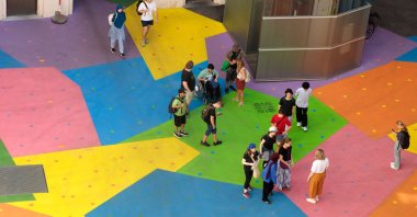 A view from above shows people on the colorfully painted ground in the courtyard of the Heidi Horten museum, Vienna, Austria, Aug. 13, 2025. (AFP Photo)