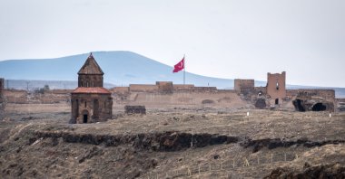 The Church of Saint Gregory stands before fortress walls and a Turkish flag near the modern border between Türkiye and Armenia, Nov. 11, 2018. (Getty Images Photo)