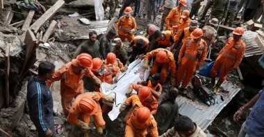 Indian rescue teams carry the body of a policeman killed in a cloudburst-triggered flash flood at a village in the Padder area of Kishtwar district, Indian-administered Kashmir, Aug. 15, 2025. (EPA Photo)