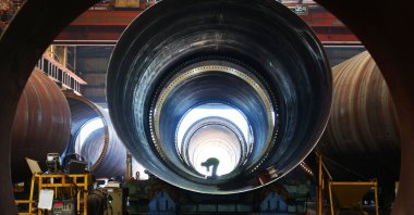 An employee works in a factory, which produces wind turbine towers to be exported overseas, in Lianyungang, China’s eastern Jiangsu province, July 29, 2025. (AFP Photo)