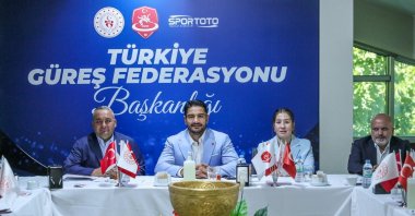 Turkish Wrestling Federation President Taha Akgül (C) poses for a photo at the Kastamonu Olympic Preparation and Camp Center, Kastamonu, Türkiye, Aug. 12, 2025. (IHA Photo)