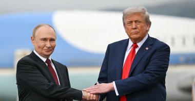 U.S. President Donald Trump greets Russian President Vladimir Putin on the tarmac after they arrived at Joint Base Elmendorf-Richardson in Anchorage, Alaska, Aug. 15, 2025. (AFP Photo)