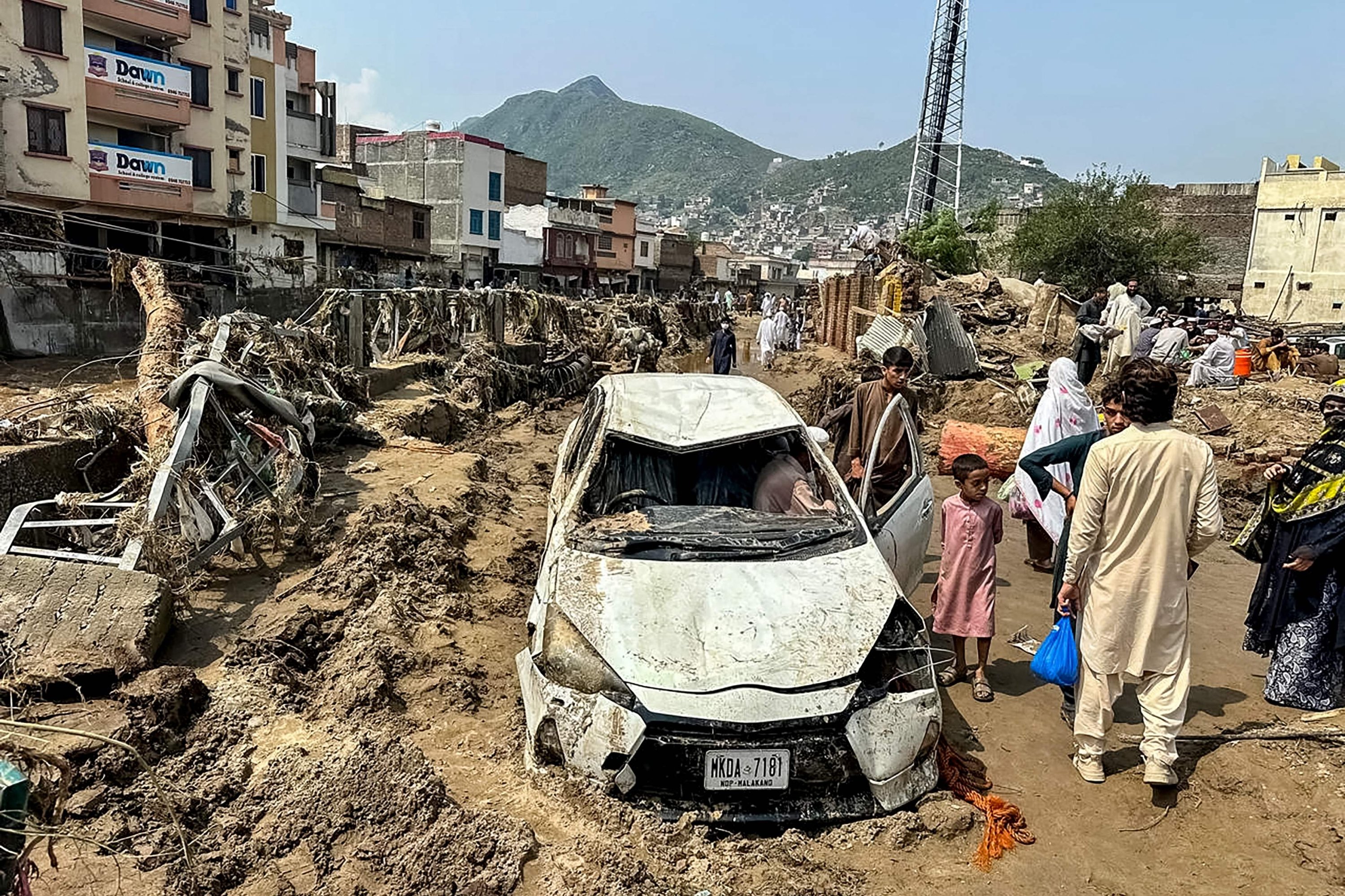 Pakistan floods kill over 300 as rescuers dig for bodies from landslides