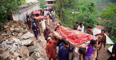 Mourners carry the coffins of flood affected victims after flash floods in Naryean Behaak village some 36 kilometers north from Muzaffarabad, the capital of Pakistan-administered Kashmir on Aug. 15, 2025. (AFP Photo)