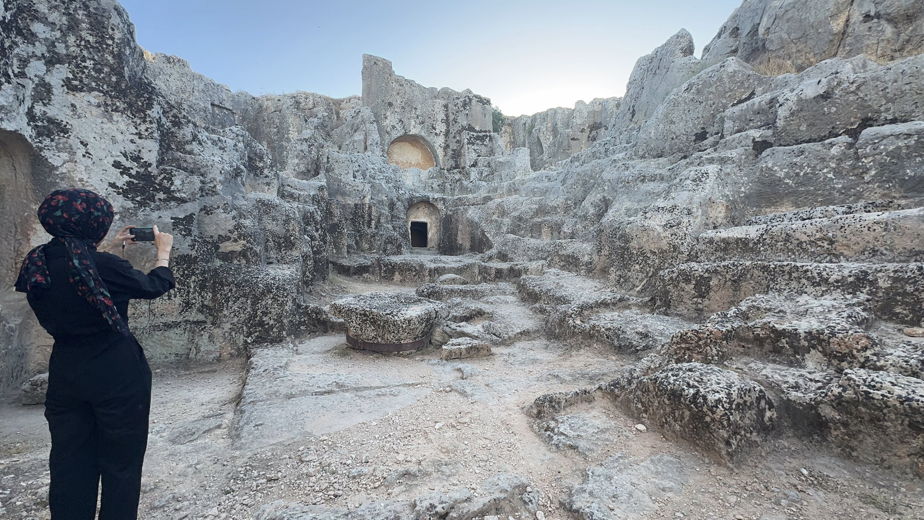 A visitor photographs the ancient city of Perre, a former Roman stopover, Adıyaman, southeastern Türkiye, Aug. 15, 2025. (AA Photo)