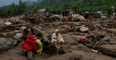 Nasir Khan, 81, sits amid the remains of damaged houses following a heavy rains and flooding, Buner, Khyber Pakhtunkhwa province, Pakistan, Aug. 17, 2025. (Reuters Photo)
