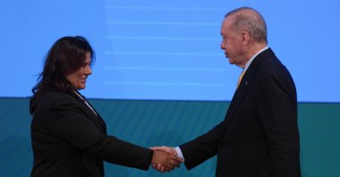 Aydın Mayor Özlem Çerçioğlu (L) shakes hands with President Recep Tayyip Erdoğan at an event, Ankara, Türkiye, Aug. 14, 2025. (AA Photo)