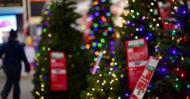 A shopper walks past artificial Christmas trees for sale at a Home Depot store, Wilmington, Delaware, U.S., Nov. 19, 2020. (Reuters Photo)