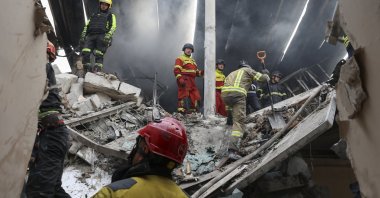 Ukrainian rescuers work at the site of a drone strike on a residential area in Kharkiv, northeastern Ukraine, Aug. 18, 2025. (EPA Photo)