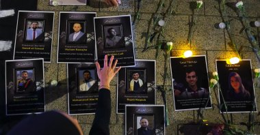Flowers are placed next to portraits of killed journalists during the &quot;Night of Remembrance for Al Jazeera journalist, Anas al-Sharif and all journalists&quot; killed by the Israeli army in Gaza, Kuala Lumpur, Malaysia, Aug. 16, 2025. (EPA Photo)
