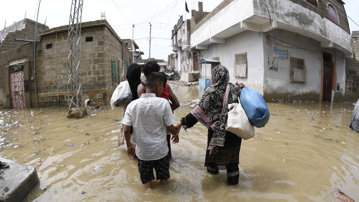People wade through rainwater after torrential rains in Karachi, Pakistan, Aug. 20, 2025. (EPA Photo)