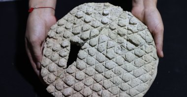 An antique baklava-pattern bread mold is displayed after excavations at the Harran ruins,  Şanlıurfa, Türkiye, Aug. 20, 2025. (AA Photo)