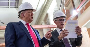 U.S. President Donald Trump points to a cost sheet as he speaks with Federal Reserve Chair Jerome Powell (R) during his visit to the Federal Reserve, Washington, U.S., July 24, 2025. (AFP Photo)