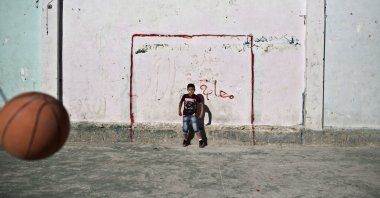 Palestinian boys use a basketball to play football in the occupied West Bank, Palestine, June 13, 2014. (AP Photo)