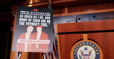 A sign showing a photo of President Donald Trump and Jeffrey Epstein is displayed ahead of a news conference with Senate Minority Leader Chuck Schumer, Democrat from New York, calling on the Trump administration to release further information on the Jeffrey Epstein case, at the U.S. Capitol in Washington, D.C., July 30, 2025. (AFP Photo)
