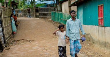 Mohammed Faruq holds the hand of his daughter Nahima Bibi, 9, as they walk along the refugee camp, Cox&#039;s Bazar, Bangladesh, Aug. 17, 2025. (Reuters Photo)