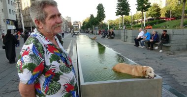 A dog cools off in a decorative fountain at Taksim Square on a hot day, Istanbul, Türkiye, Aug. 4, 2025. (IHA Photo)
