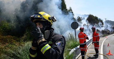 Firefighters try to control a wildfire near the village of Mougas, in Oia municipality, northwestern Spain, Aug. 22, 2025. (AFP Photo)