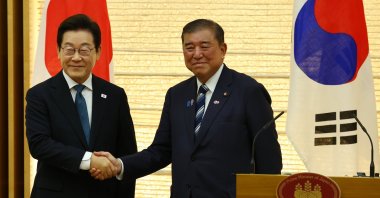 South Korean President Lee Jae Myung (L) and  Japan&#039;s Prime Minister Shigeru Ishiba shake hands at joint press announcement after the summit in Tokyo, Japan, Aug. 23, 2025. (EPA Photo)